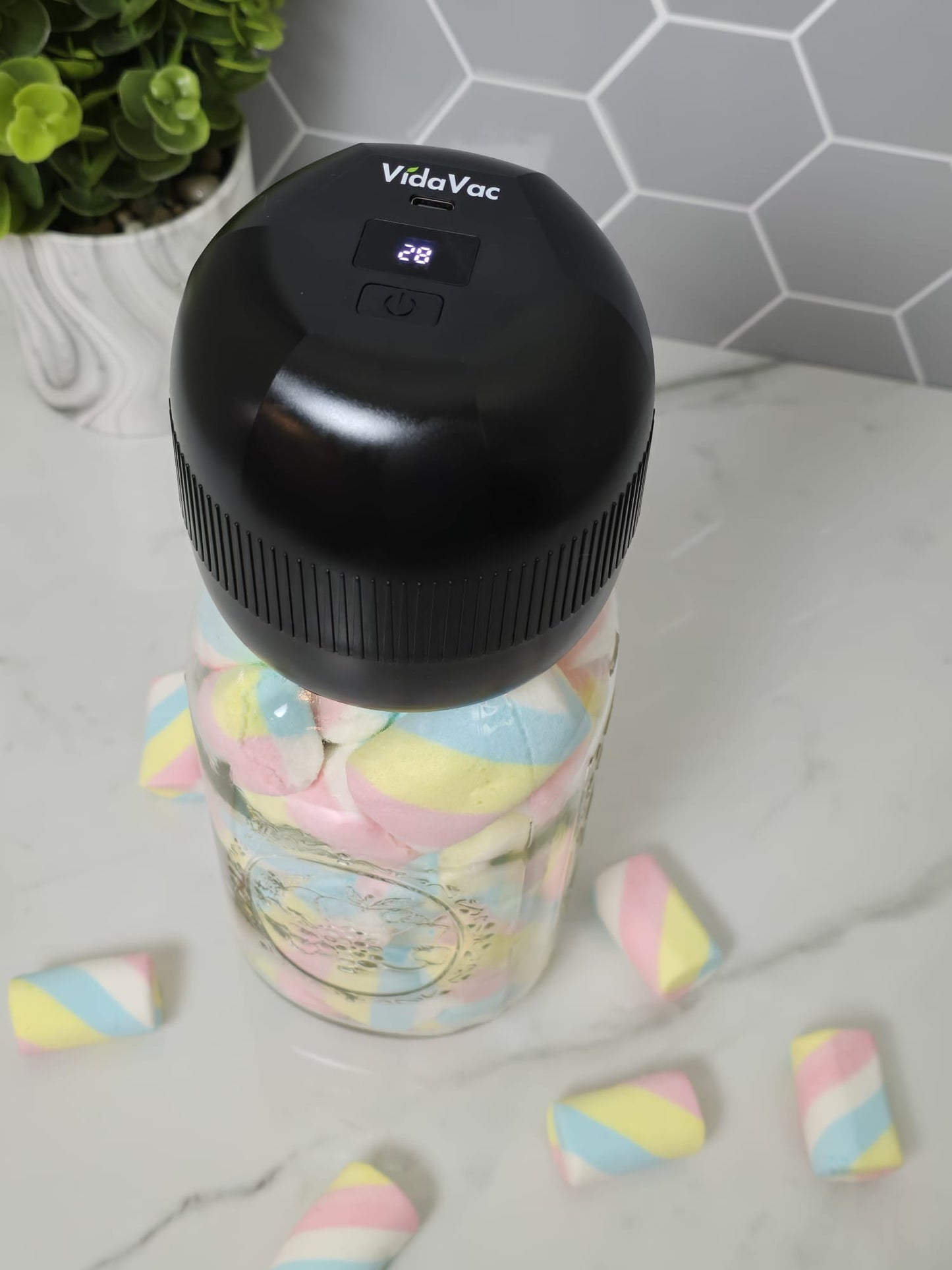 acuum sealing a mason jar filled with marshmallows using the VidaVac electric vacuum sealer