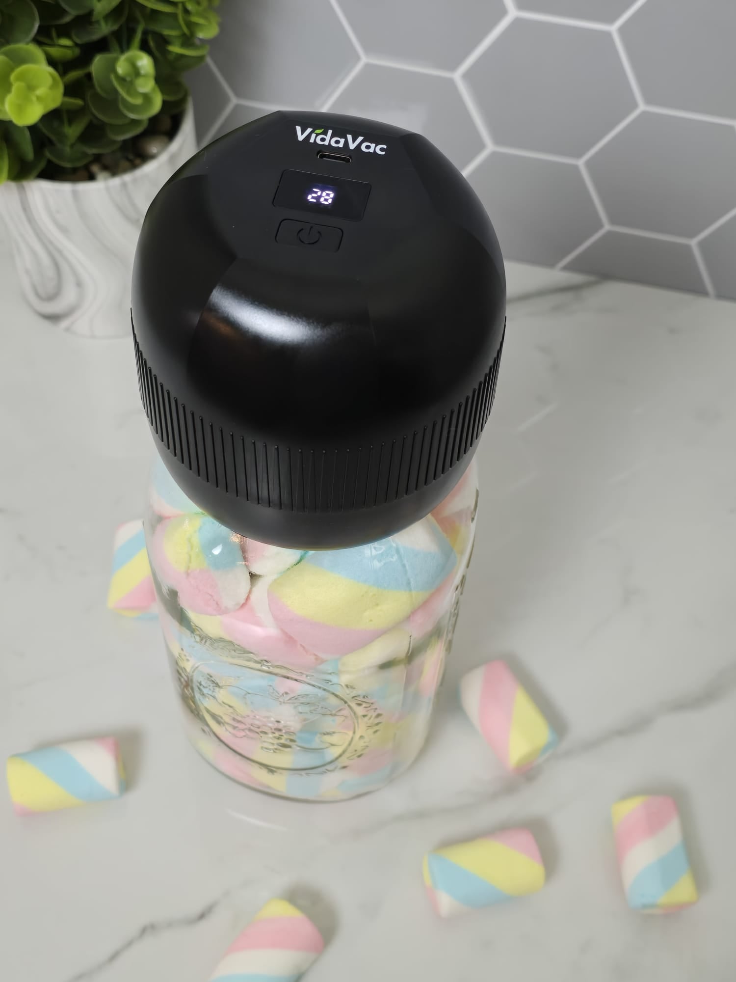 acuum sealing a mason jar filled with marshmallows using the VidaVac electric vacuum sealer