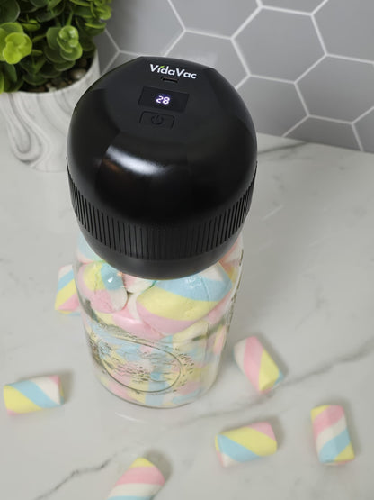 acuum sealing a mason jar filled with marshmallows using the VidaVac electric vacuum sealer